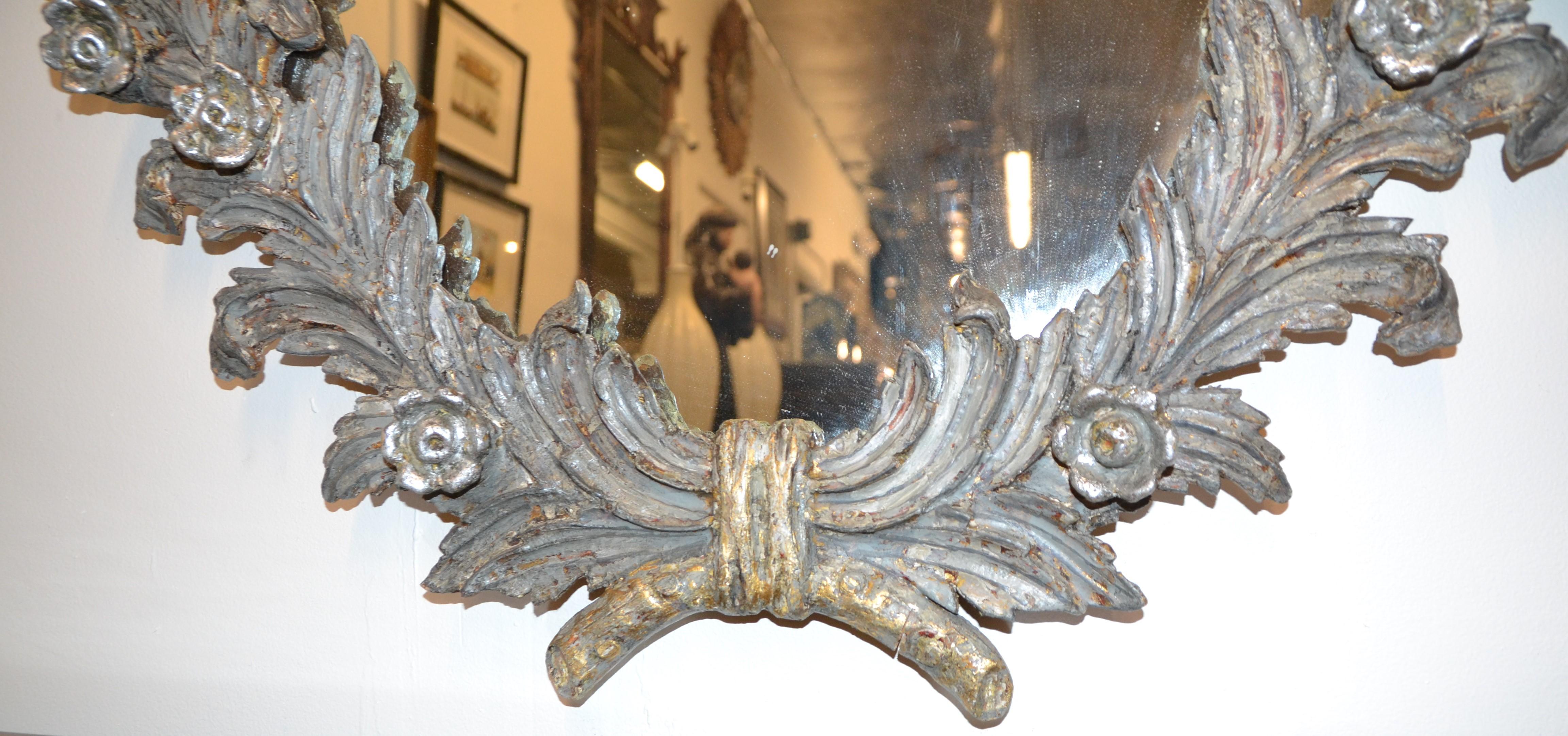 Mirror with wood carved leaves and flowers. Gray and silver finish.