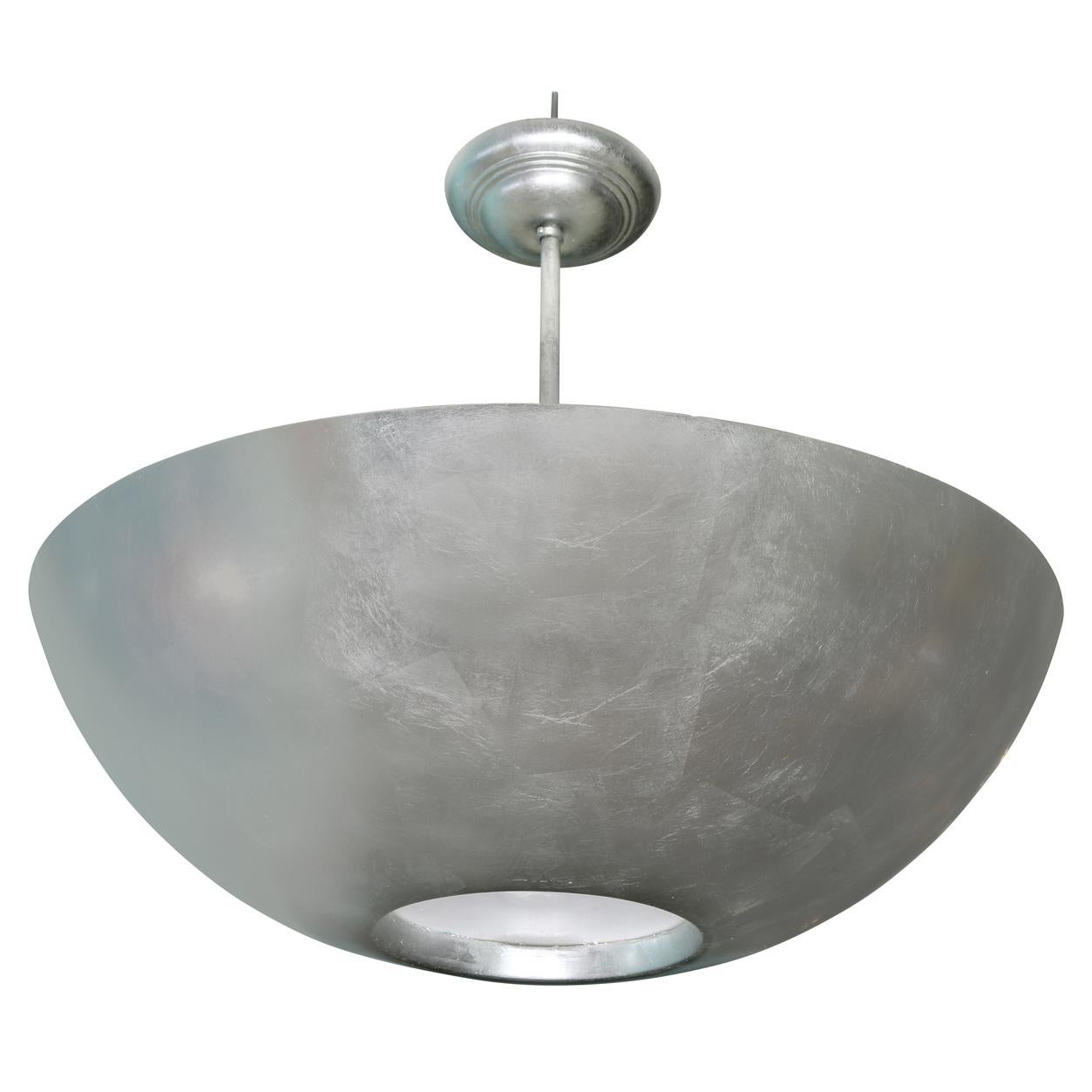 A large vintage plafonnier in modern style with an inverted half dome shape, silver leaf finish to resin or fiberglass and a light diffuser at base.