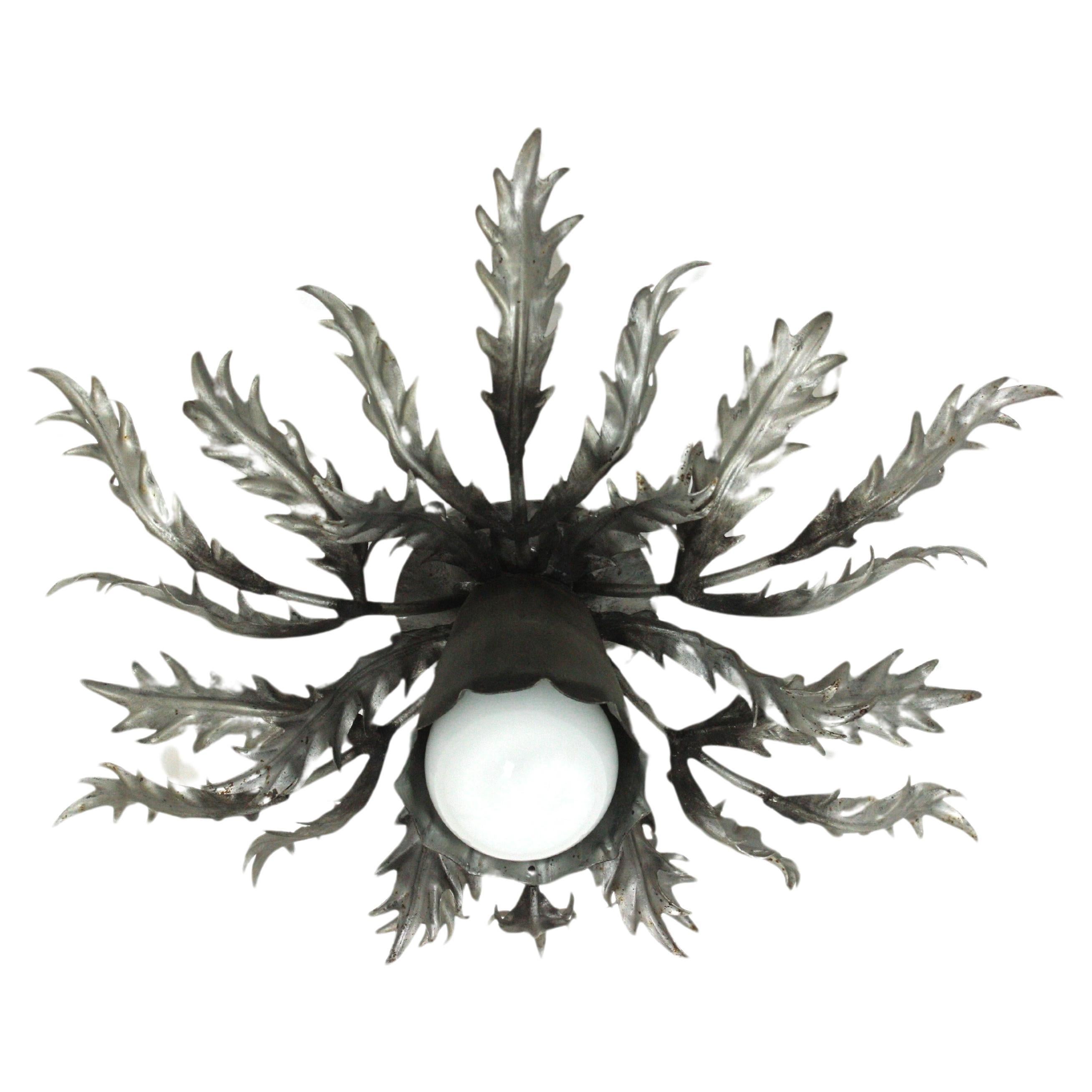 Spanish Foliage Sunburst Flush Mount Light Fixture in Silvered Iron
Stunning foliage sunburst ceiling light fixture, gilt iron, silver leaf, Spain, 1950s.
This eye-catching iron ceiling lamp features a double layered leafed frame of leaves