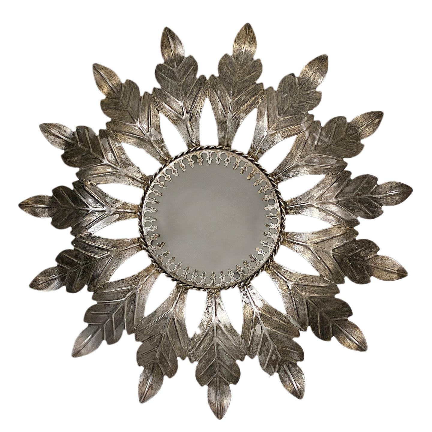 A circa 1950's Italian silver leaf sunburst pendant light fixture with glass inset and two candelabra lights.

Measurements:
Drop: 8