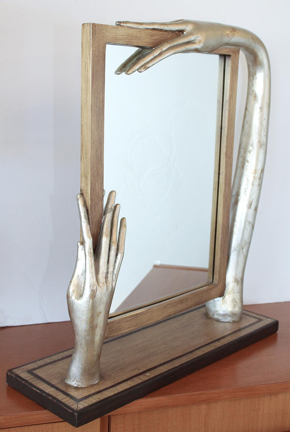 Silver leaf and painted wood mirror with surrealistic elongated arm and hands in the manner of Amadeo Modigliani, circa 1980. Very good condition.