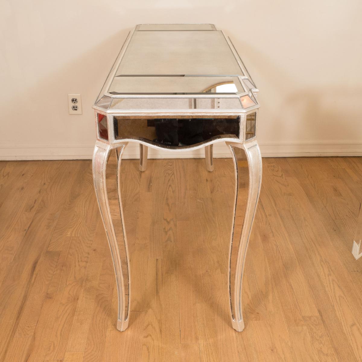 Silver leafed wood and mirror vanity table with cabriole legs.