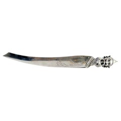 Silver letter opener with engraving and a goblin
s head on the handle