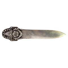 Silver letter opener with wreaths and floral motifs, engraved on the blade