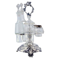 Silver liqueur bottle with floral motifs, mascaron feet, and spice deposits