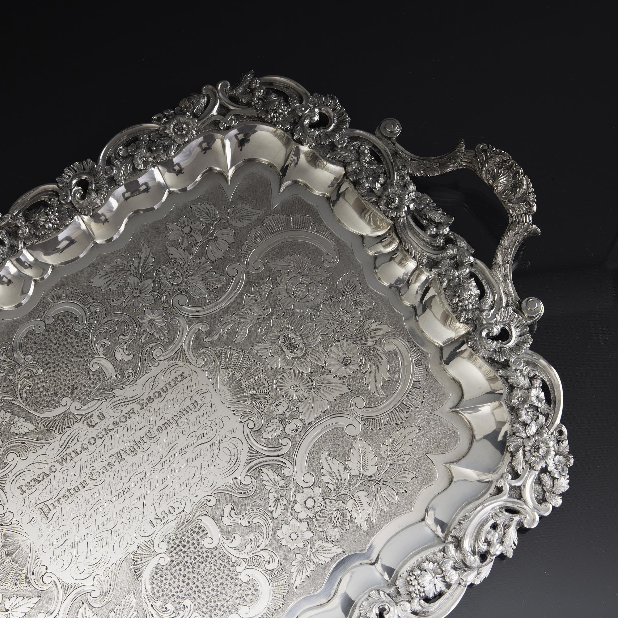 Superb quality and highly decorative two-handled antique silver tray. Fitted with two cast scroll, leaf and scallop shell pattern handles, an applied cast border decorated with intricate openwork patterns runs around the tray, and incorporates