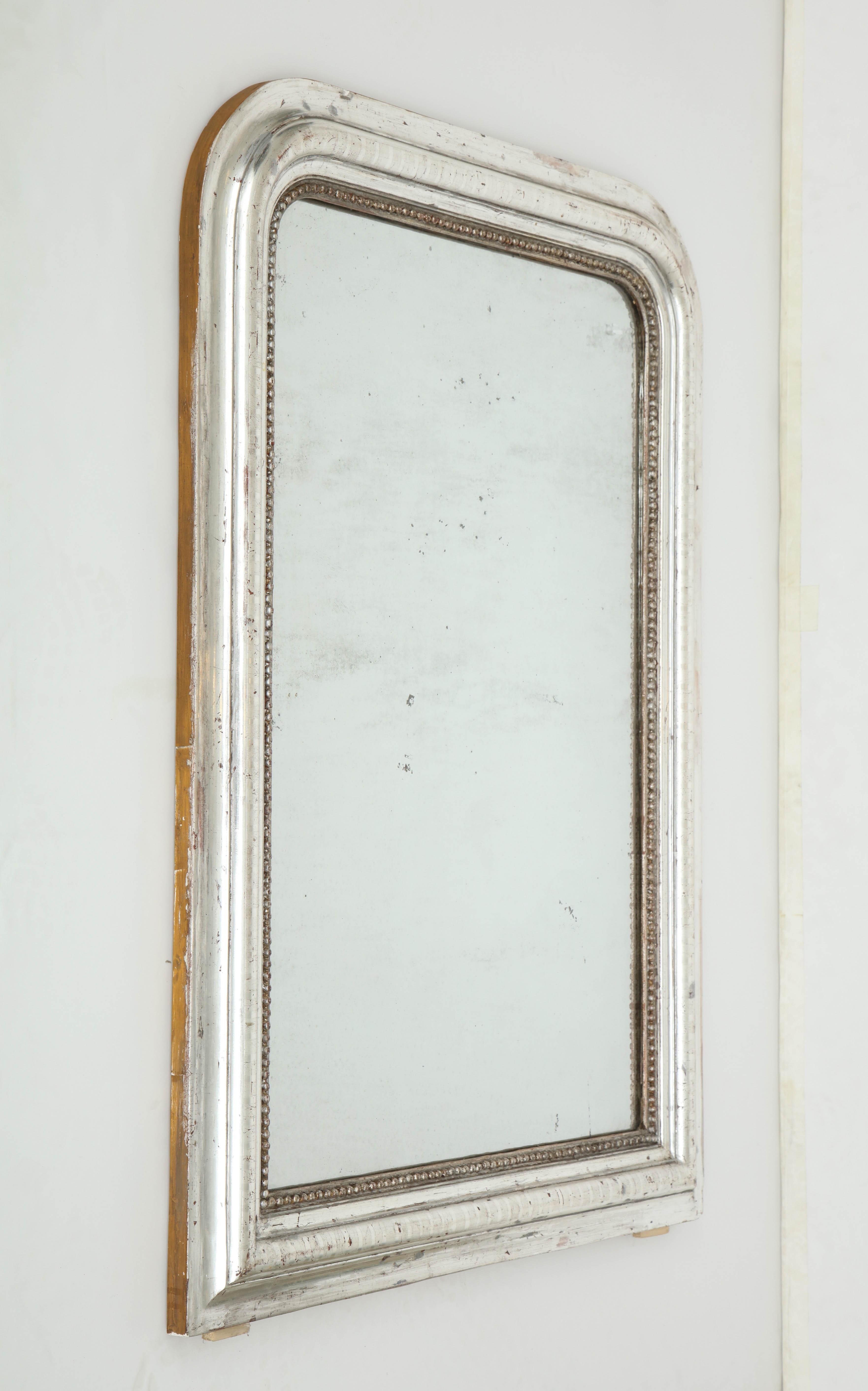 We love the simple form of this Louis-Philippe mirror. Rectangular, with rounded top corners, the mirror is silver leafed and features a subtle geometric design on the frame.