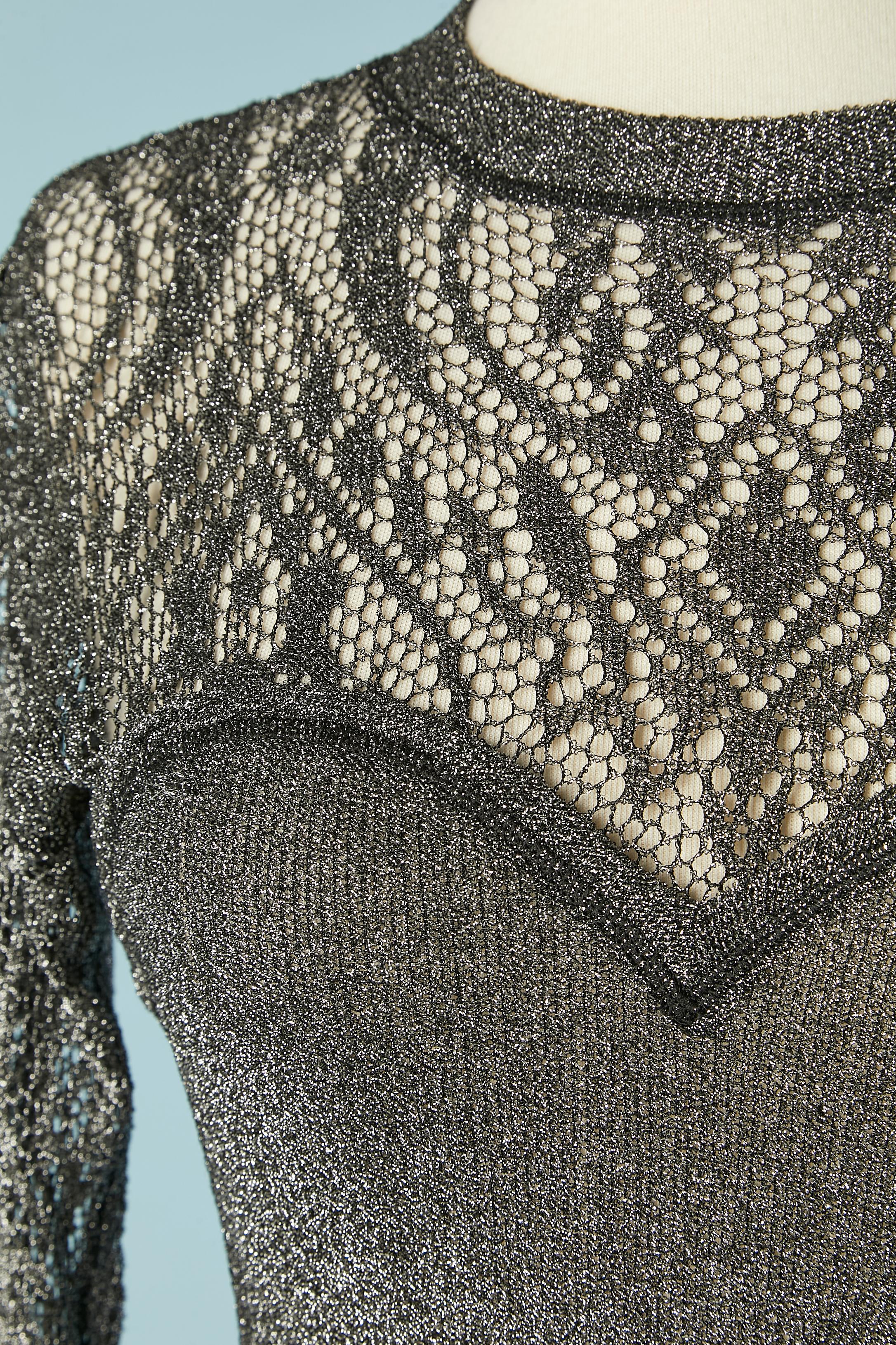 Silver lurex knit and lace cocktail dress . 
Fabric composition: 69% rayon, 25% nylon, 6% lycra . See-through on the top front and back. 
SIZE 38 (Fr) / 6 (US) / S 