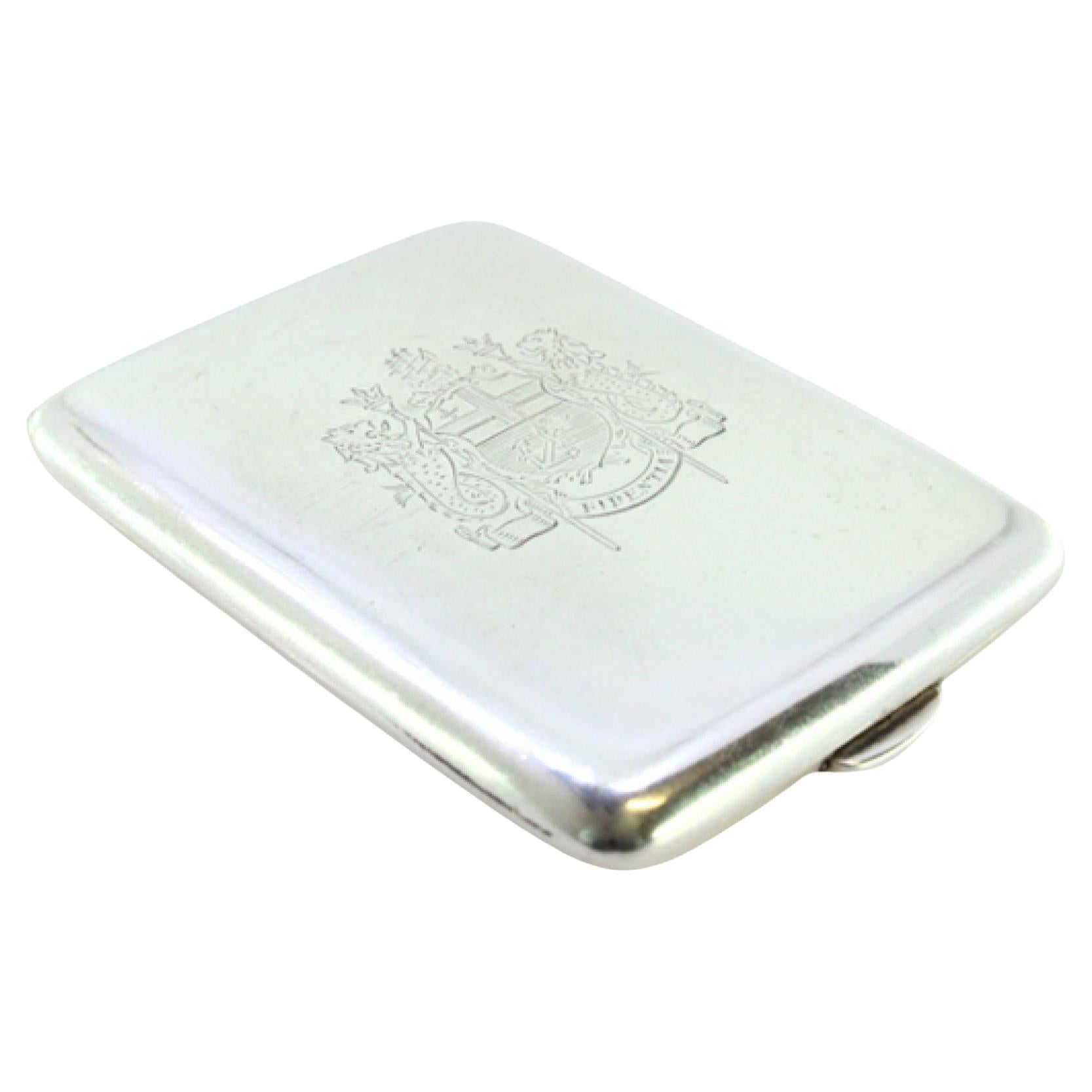 Silver matchbook with coat of arms in the center and hinged lid