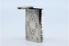 Silver matchbox book-shaped with plant engravings and sliding opening