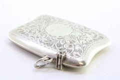Silver matchbox with floral engravings, monogram and hanging ring