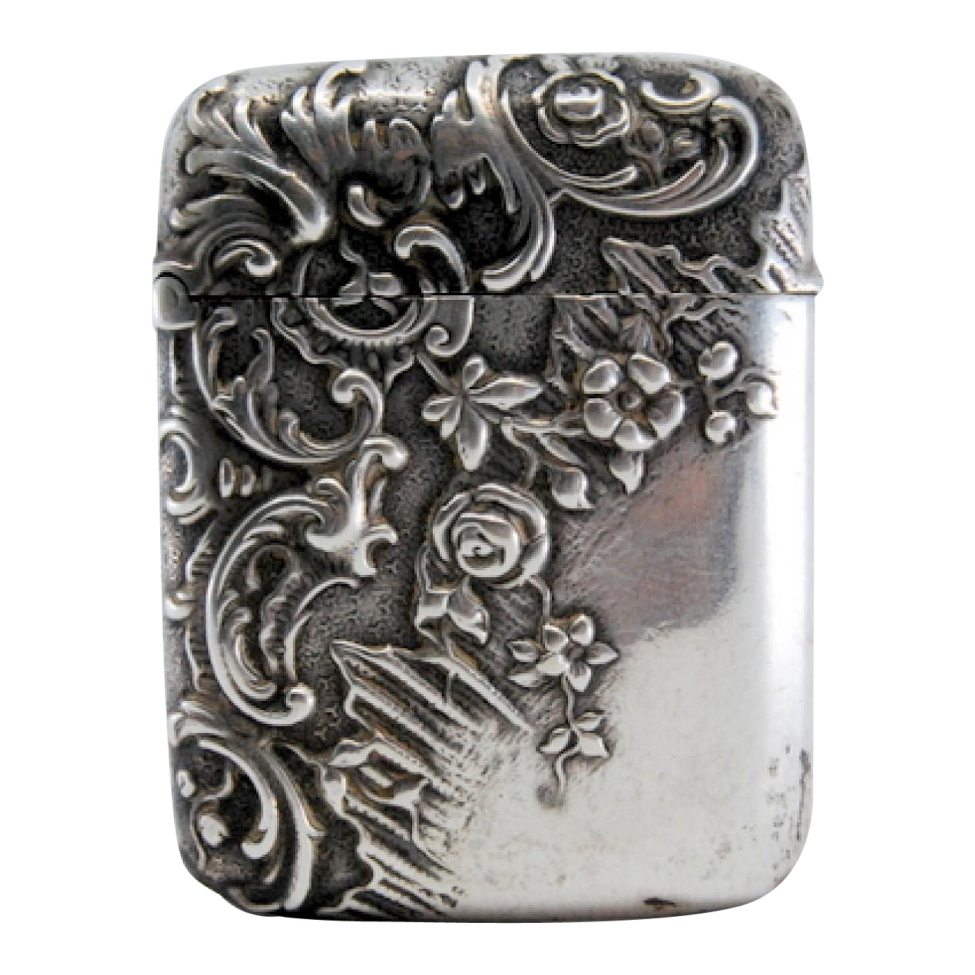 Silver matchstick with relief plant motifs surrounding monogram cartouche For Sale