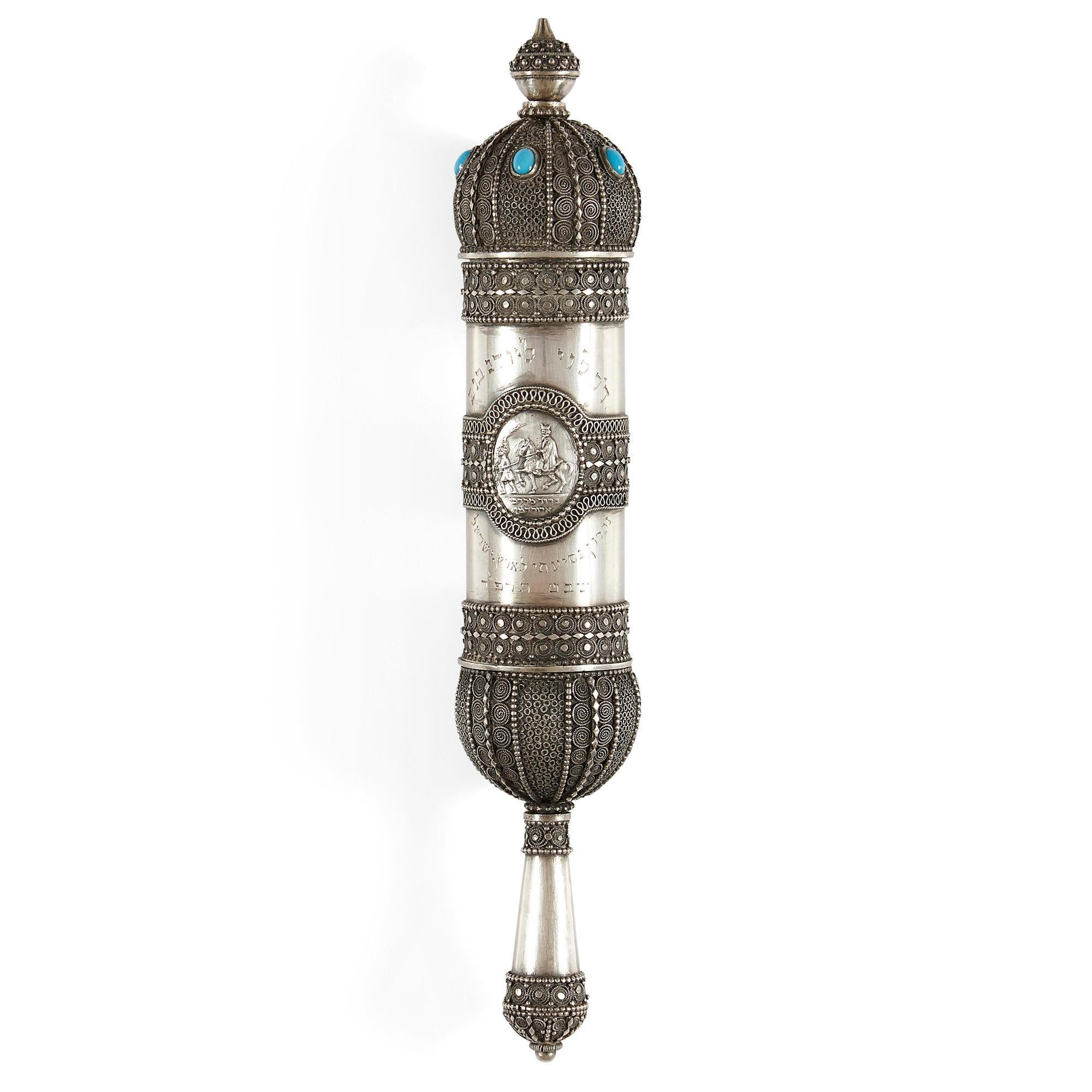 Silver Megillah with filigree work by Bezalel Academy
Jerusalem, c. 1920
Measures: Height 22cm, diameter 4cm

This beautiful silver megillah was crafted in the early 20th century by the prestigious Bezalel Academy of Arts and Design in