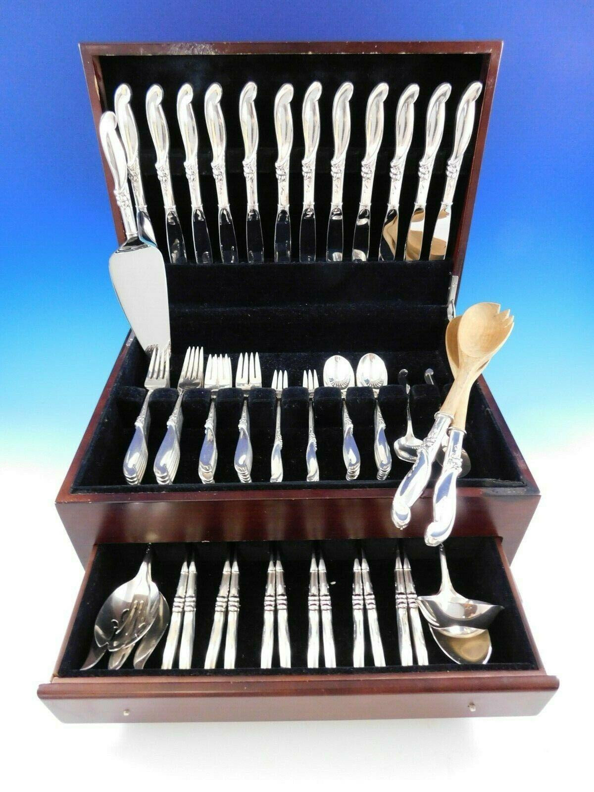 Silver Melody by International sterling silver Flatware set with cool modern shaped handle, 82 pieces. This set includes:

12 knives, 9 1/4