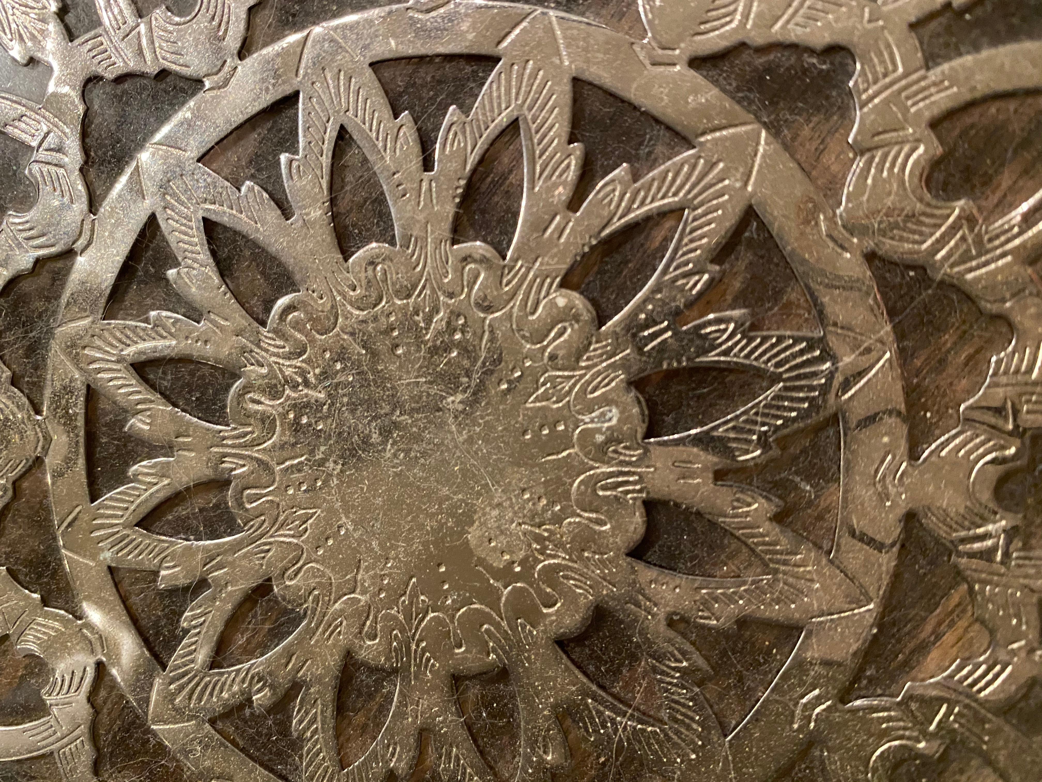Early to mid-20th century etched silver plate overlay glass trivet. The metal work is detailed with tracery and etched design. A beautiful detail for any kitchen. Great for setting hot pots and pans and a great accent for the countertop or dining