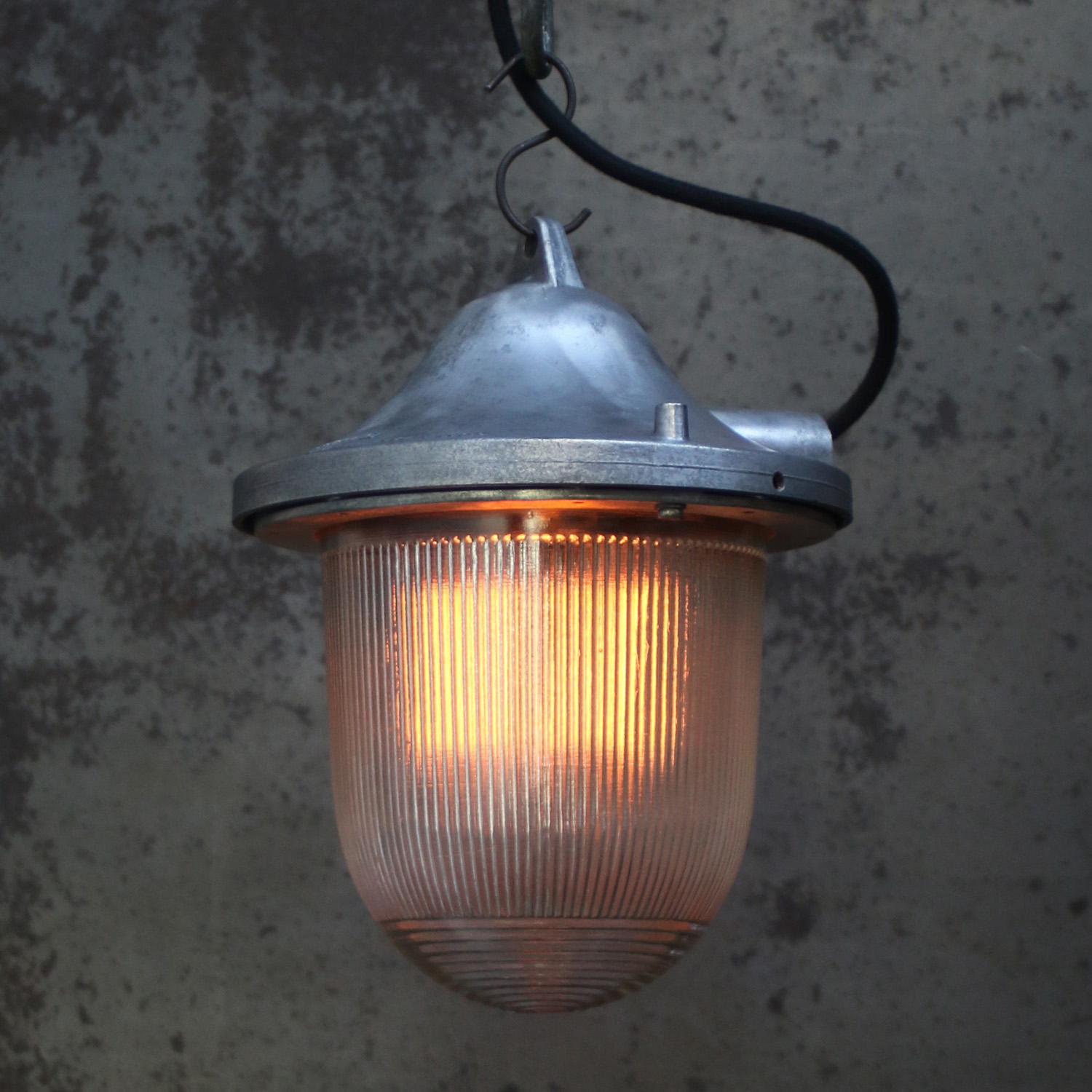 Industrial hanging lamp
clear striped glass
grey cast aluminium top

Weight: 2.90 kg / 6.4 lb

Priced per individual item. All lamps have been made suitable by international standards for incandescent light bulbs, energy-efficient and LED bulbs. The