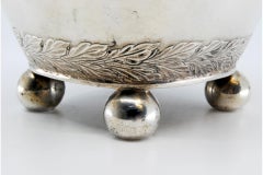 Silver milk jug with friezed lid, knob, on four ball feet in D. Maria style