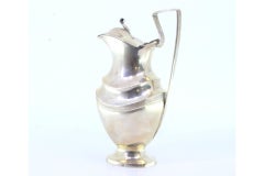 Silver milk jug with knob on the hinged lid and strips on the circular base