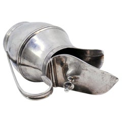 Silver milk jug with knobbed hinged lid, rim and base friezes, D. Maria style