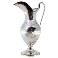 Silver milk jug with knobbed lid and pearly friezes on circular base