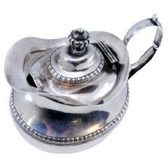 Silver milk jug with pearly trim and knob on the hinged lid