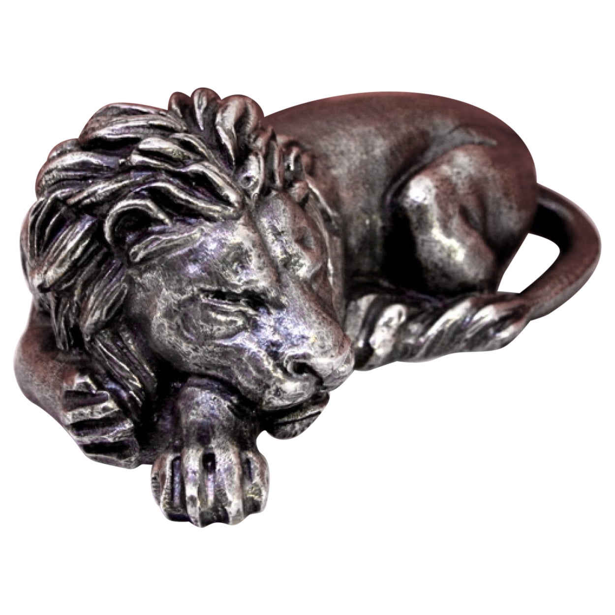 Silver miniature lion revealed in lying position