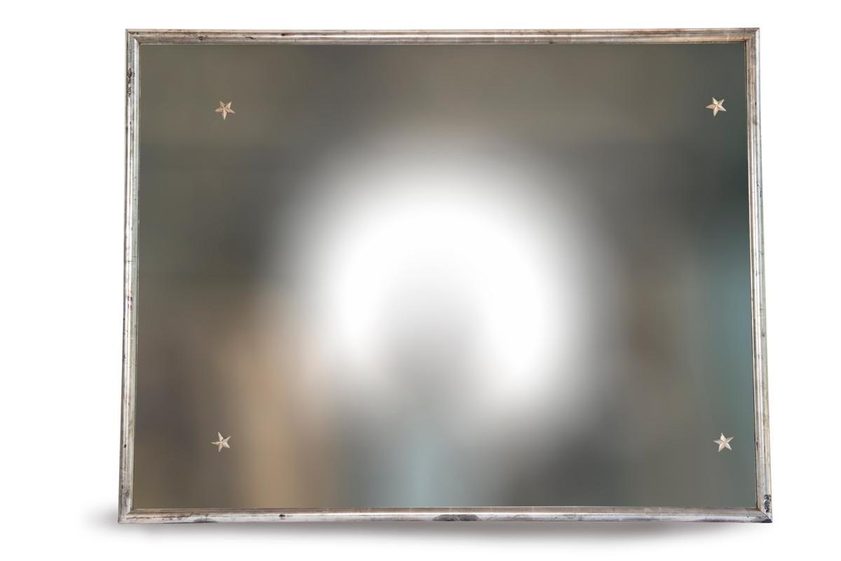 Silver mirror with star decoration and original glass.