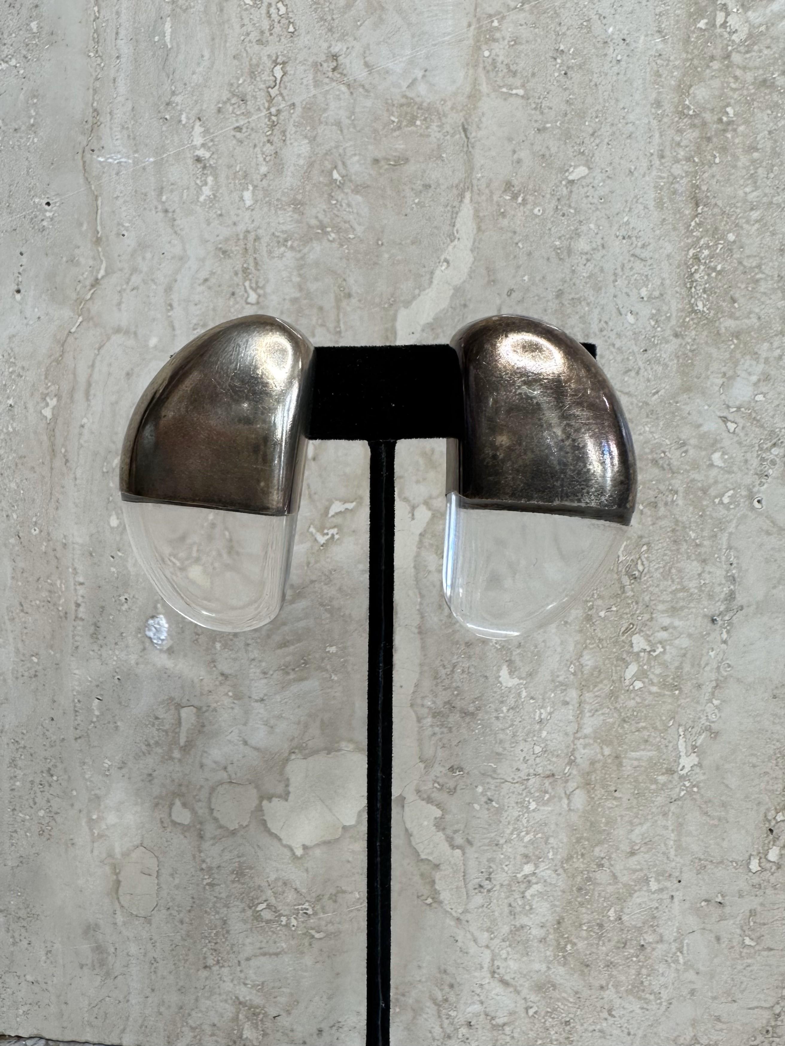 Silver Moon Lucite earrings sound like a beautiful piece of jewelry! Based on the description, it seems like they could be made from lucite (a type of acrylic plastic known for its clarity and ability to be molded into various shapes), with a design