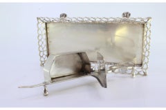Silver morrões tray and scissors with a rack resting on four claw-shaped feet