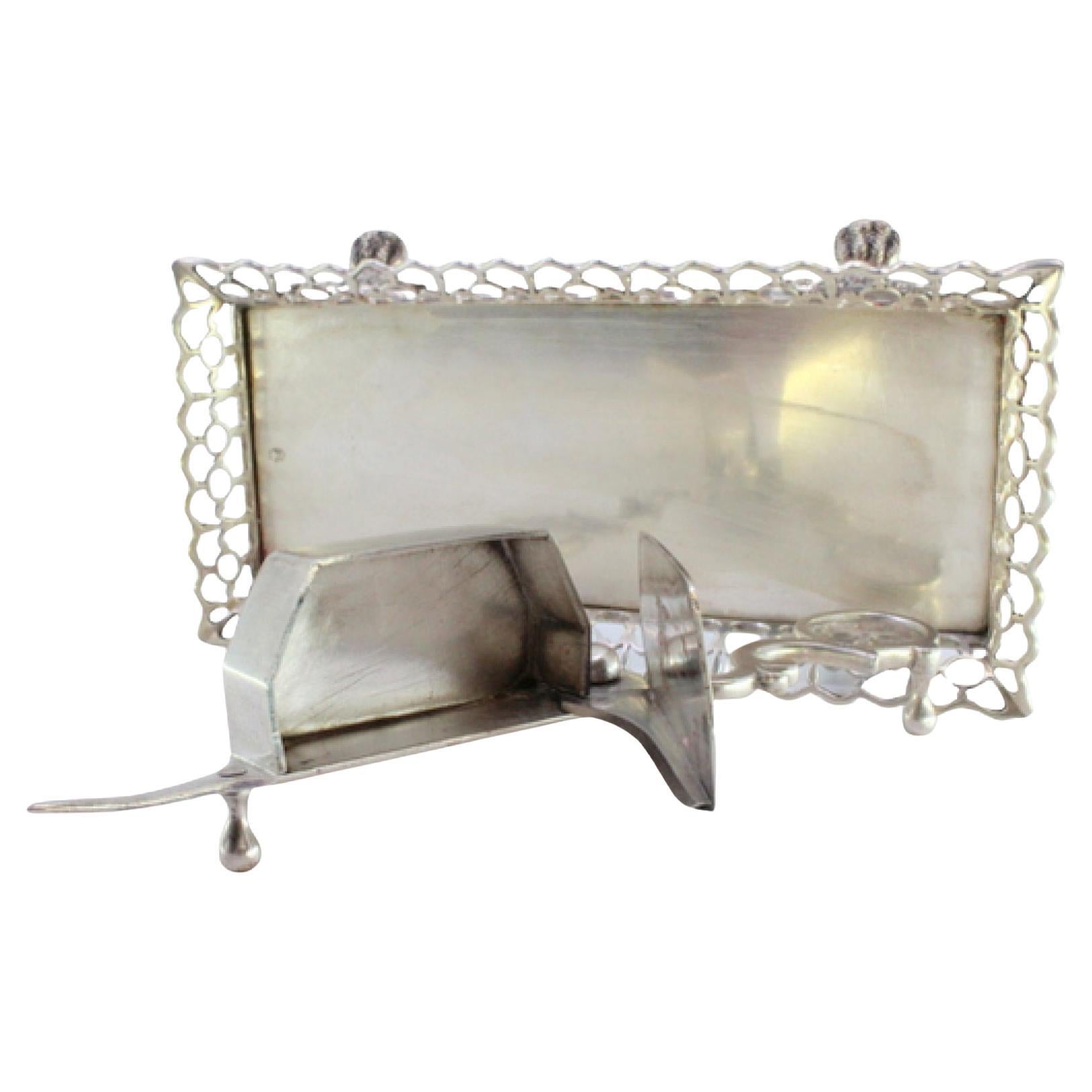 Silver morrões tray and scissors with a rack resting on four claw-shaped feet