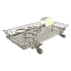 Silver morrões tray 
scissors w/ a rack resting on four raised claw-shaped feet