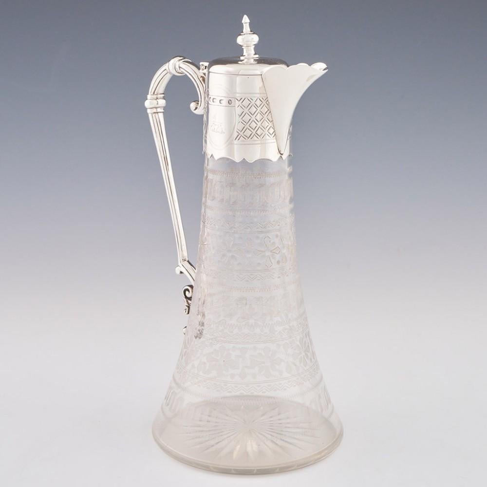 Heading : Sterling silver and glass claret jug
Date : Hallmarked in Birmingham in 1876 for Barker Brothers
Period : Victoria
Origin : Birmingham, England
Colour : Silver cover and handle, clear glass body
Body : Machine engraved with Greek keys and