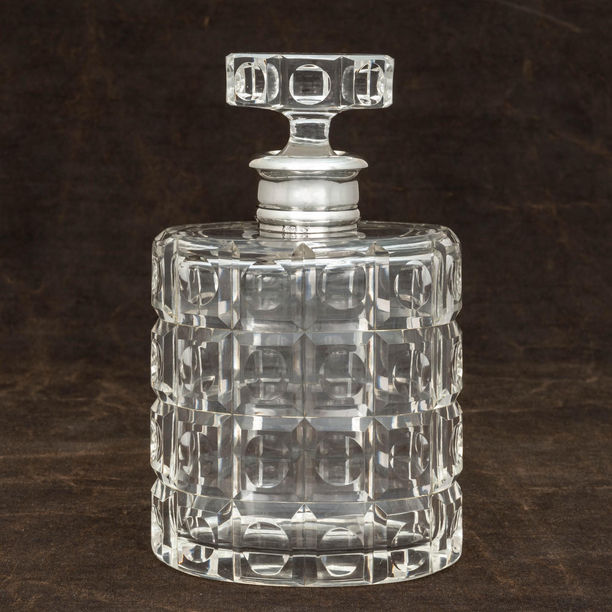 Cut glass geometric pattern decanter with silver collar, by Fratelli Cacchione, Milan, Italy. Stamped with the maker’s number, 39MI. Also marked with the oval silver purity mark 925 (the same purity as Sterling). Fantastic quality!.

Dimensions: