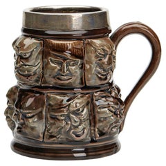 Silver Mounted Thirteen Grotesque Faces Molded Glazed Pottery Mug