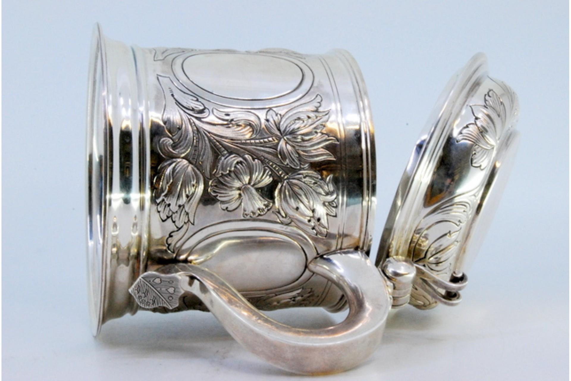 European Silver mug with relief floral motifs surrounding monogram cards For Sale