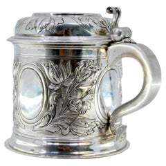 Silver mug with relief floral motifs surrounding monogram cards