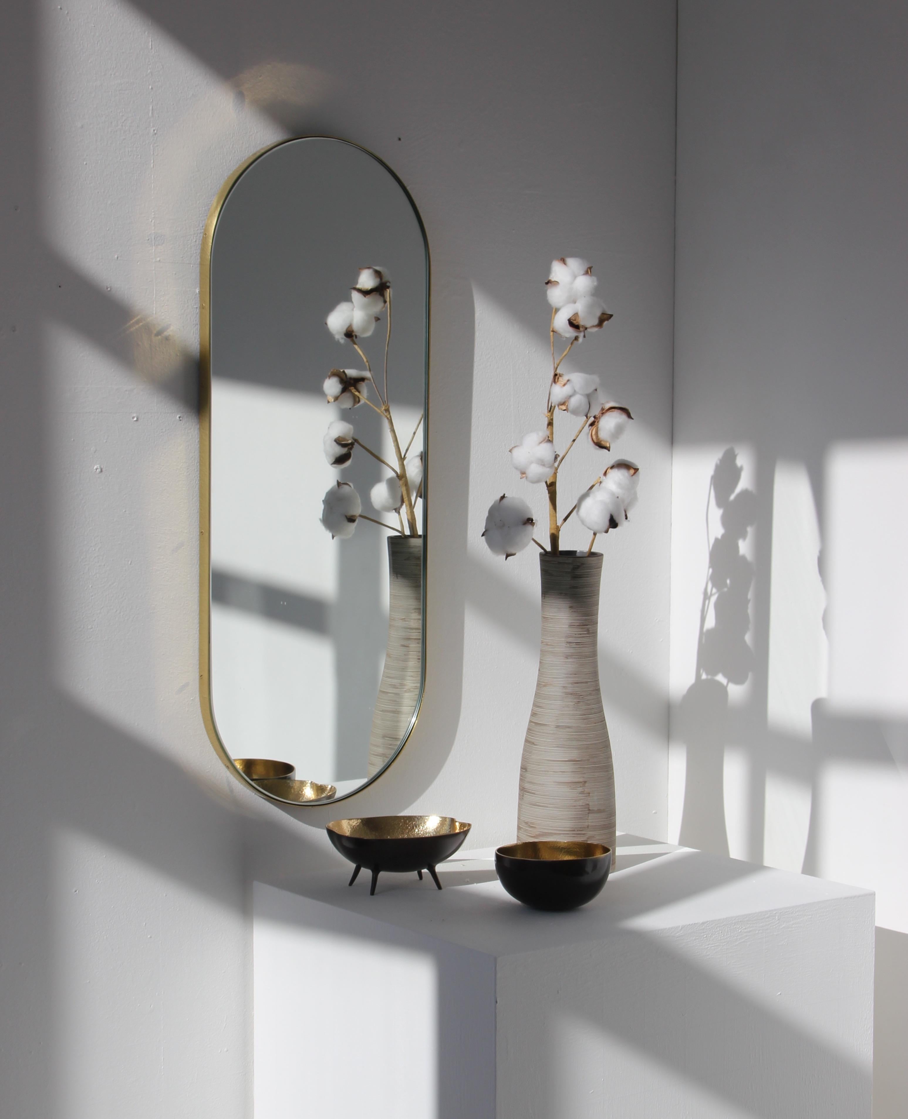 Schöner kapselförmiger Spiegel mit einem eleganten Rahmen aus gebürstetem Messing. Entworfen und handgefertigt in London, UK.

Die mittelgroßen, großen und extragroßen Spiegel (37 cm x 56 cm, 46 cm x 71 cm und 48 cm x 97 cm) sind mit einem