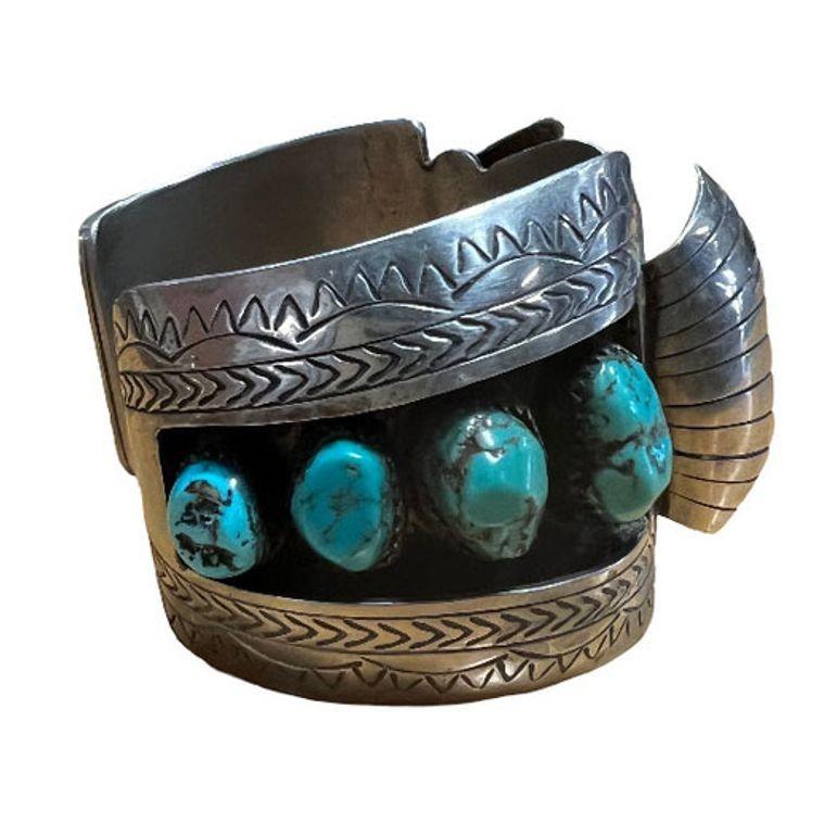 Navajo silversmith watchband/cuff styled after the work made by Hyson Craig, this classic combination of heavy silver and American turquoise stone. The cuff is filled with a magnificent collection of Kingman Turquoise stones.

The combination of