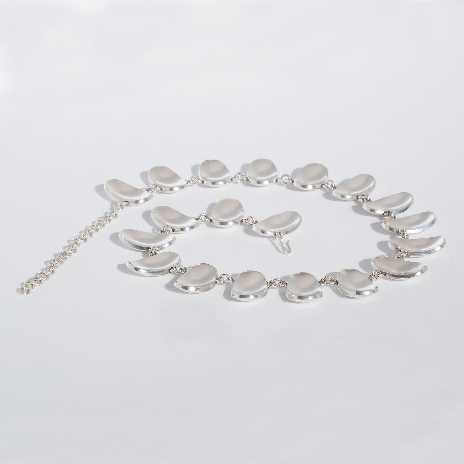 Diese Halskette aus Sterlingsilber besteht aus 19 ovalen, schön gewölbten Scheiben. Die Kette ist verstellbar und lässt sich leicht mit einem Haken schließen.

Die Halskette hat einen klaren Glanz und passt sowohl zum Abend- als auch zum