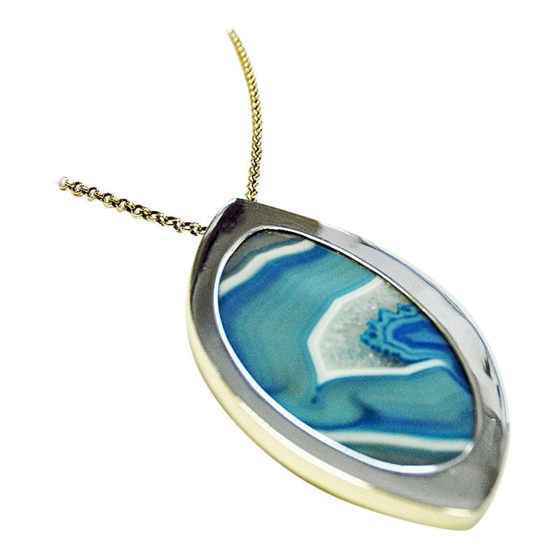 Stunning necklace by Marianne Berg for Uni Davidsen with a beautiful clear blue and white patterned agate stone surrounded by a polished silver frame. From the 1960s. The pendant is flat stone with amazing blue and white stone. Glazed and smooth