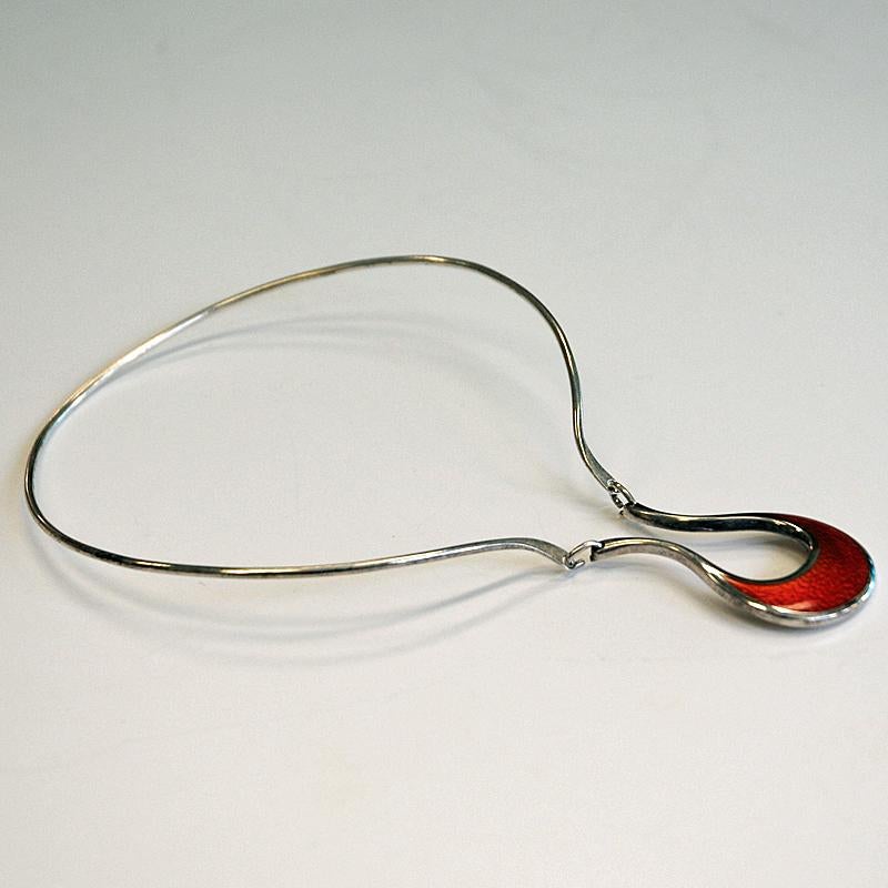 Elegant sterling silver necklace with a beautiful red enameled pendant by Finnish designer Pekka Piekäinen (1945 - 2004) for Kultakeskus, Åbo Finland 1977. Size: 18.5 cm H x 12 cm W. Pendant width: 3 cm. Weight: 23 gram. Inner diameter: 12 cm.