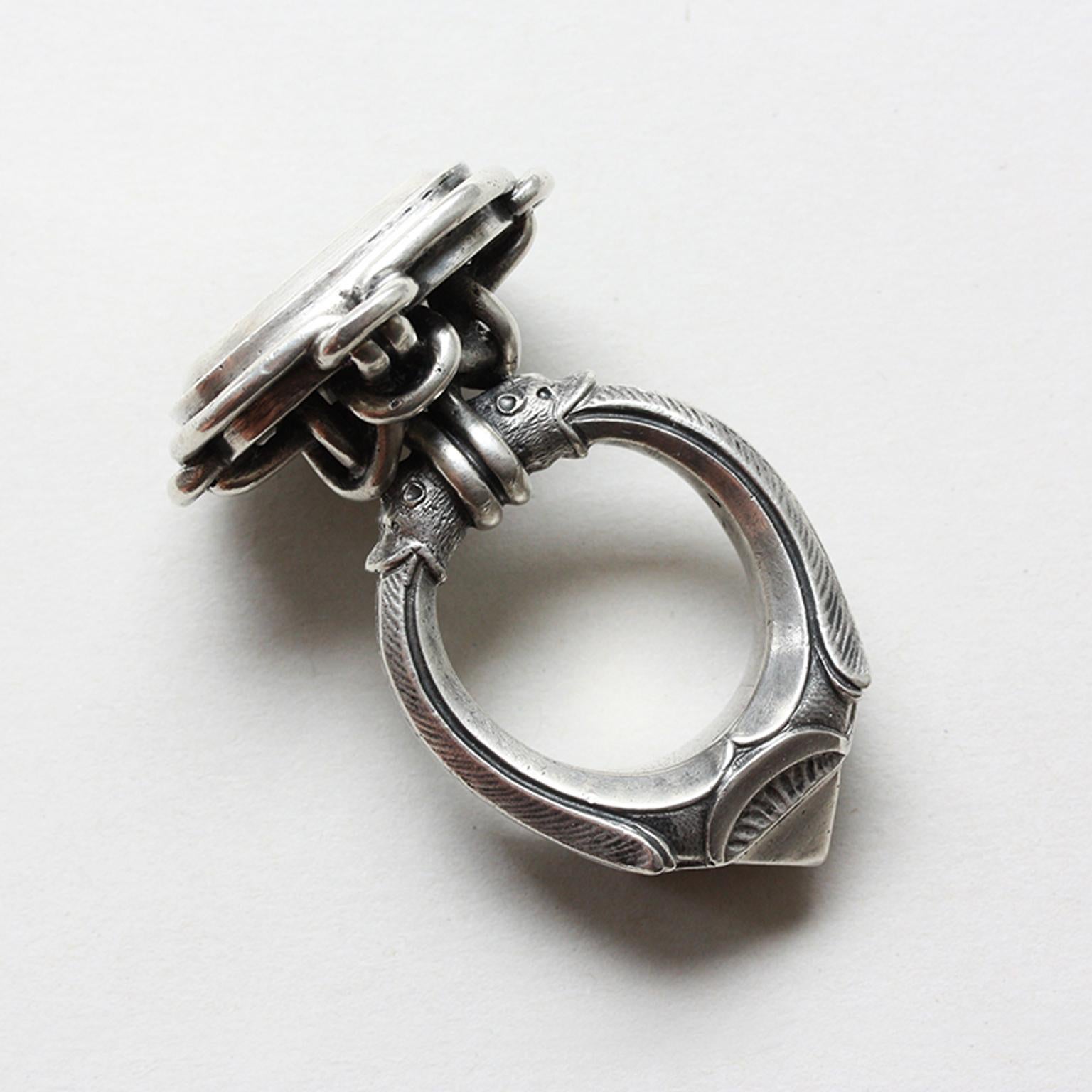 A large silver Neo Renaissance desk seal or presse papier in the form a Renaissance ring with an octahedron diamond set in a quatrefoil bezel. The shank is held by the mouths of two animals. With the initials JPL. France circa 1870.

Weight: 73.5