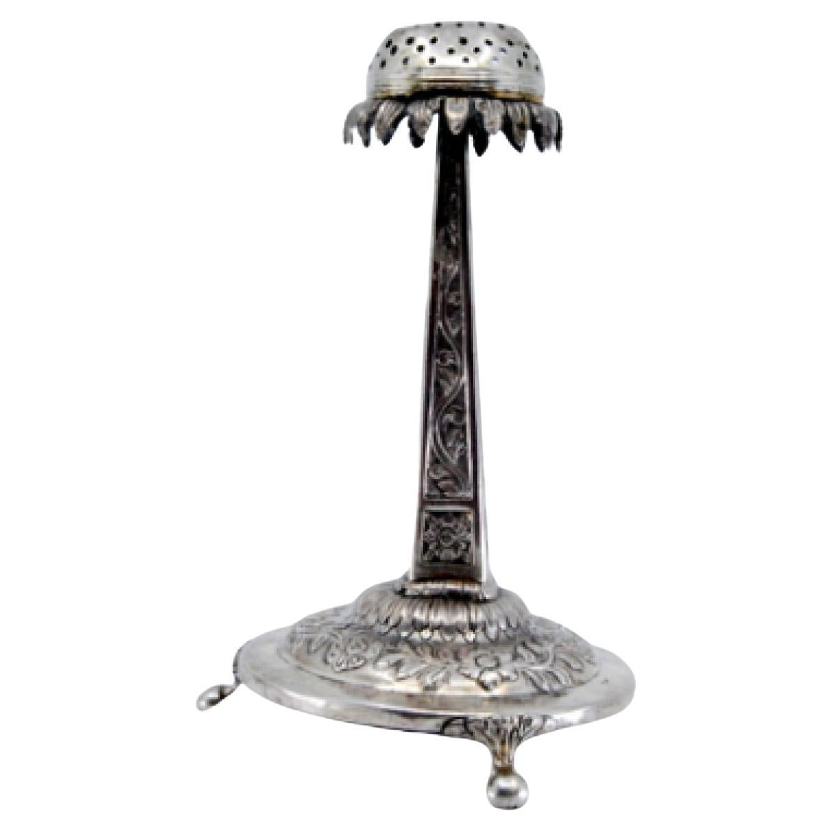 Silver obelisk-and-flower toothpick holder on floral three-foot base