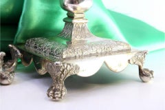 Silver obelisk candlesticks with floral palms on square bases with claw feet