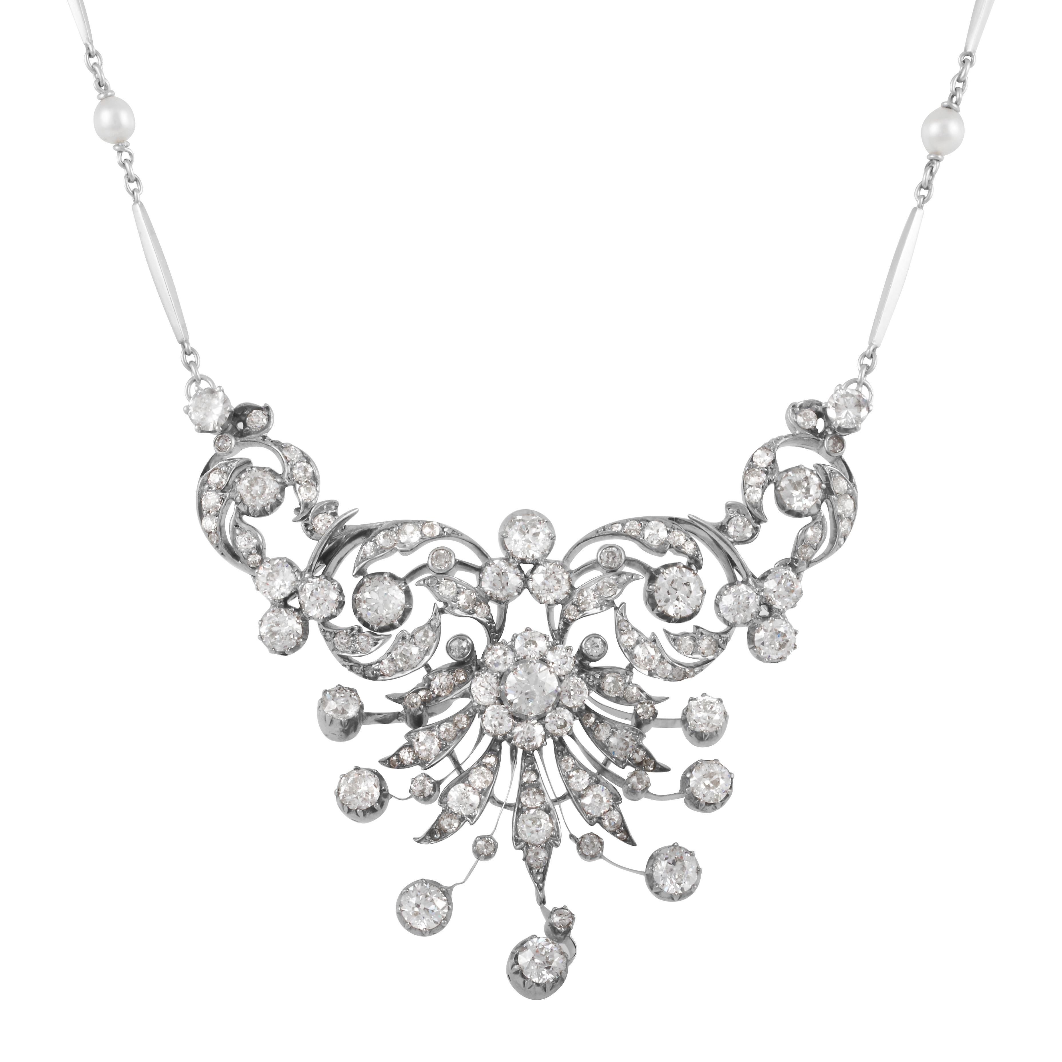 This antique necklace features a mix of Old Mine Cut, Old European Cut, and Single Cut diamonds totaling approximately 10.50 carats with H-I-J color and VS2-SI2 clarity.  The setting of the necklace is silver on 14k yellow gold, it hangs from a