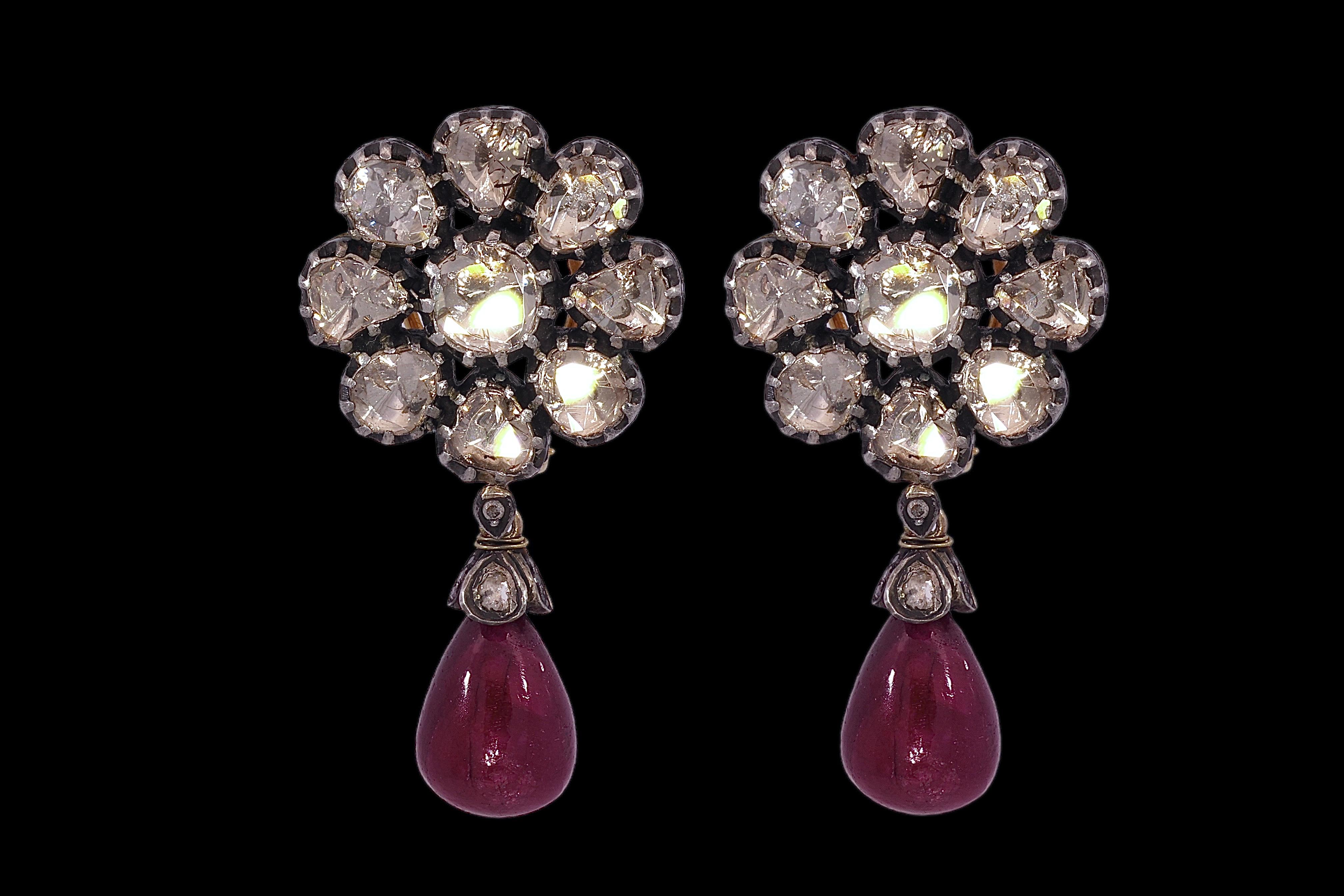Gorgeous Silver on Gold Earrings With Rose Cut Diamonds in Flower Shape with Ruby Dangling Down 

Diamonds: Rose cut diamonds

Ruby: 2 pear shape rubies 

Material: Silver on gold

Measurements: 49.5 mm x 26.1 mm x 20.7 mm

Total weight: 30.1 gram /