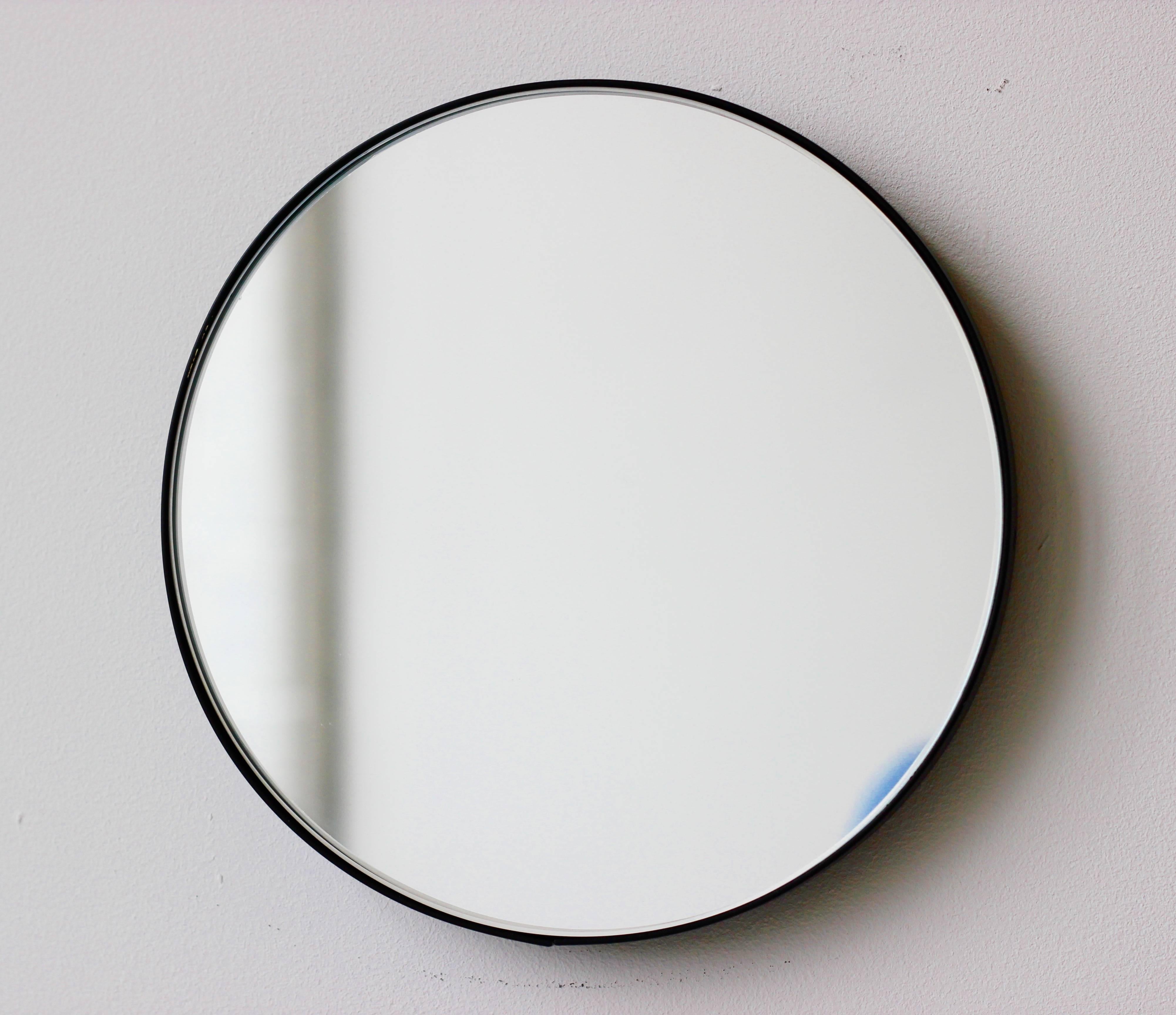 Minimalist Orbis™ round mirror with an elegant aluminium powder coated black frame. Designed and handcrafted in London, UK.

Medium, large and extra-large mirrors (60, 80 and 100cm) are fitted with an ingenious French cleat (split batten) system so