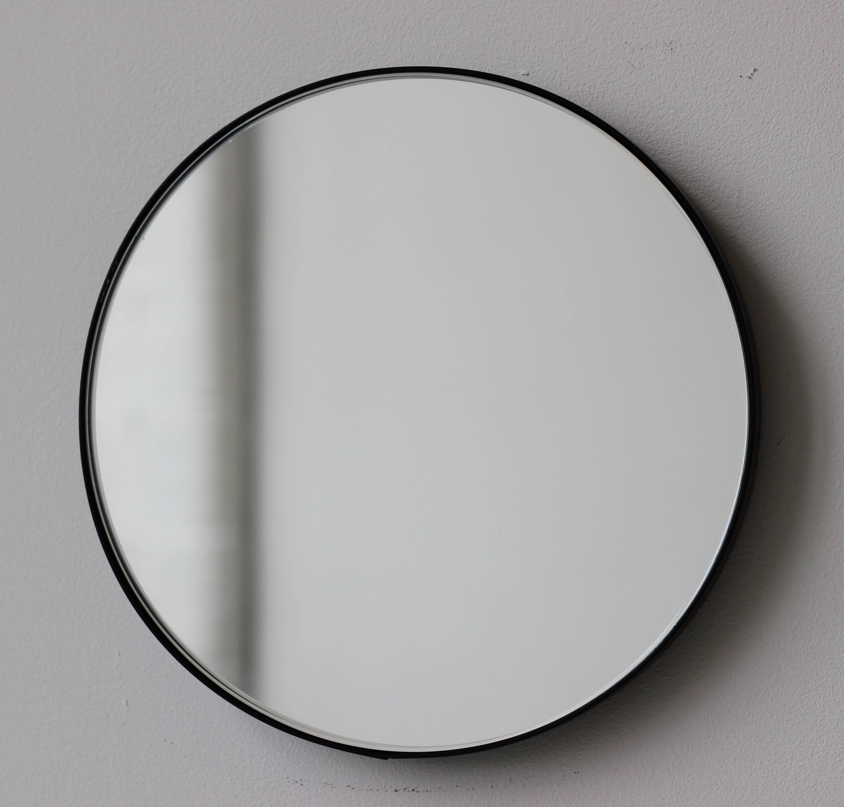 Minimalist round mirror with an elegant black powder coated aluminium frame. Designed and handcrafted in London, UK.

Medium, large and extra-large mirrors (60, 80 and 100cm) are fitted with an ingenious French cleat (split batten) system so they