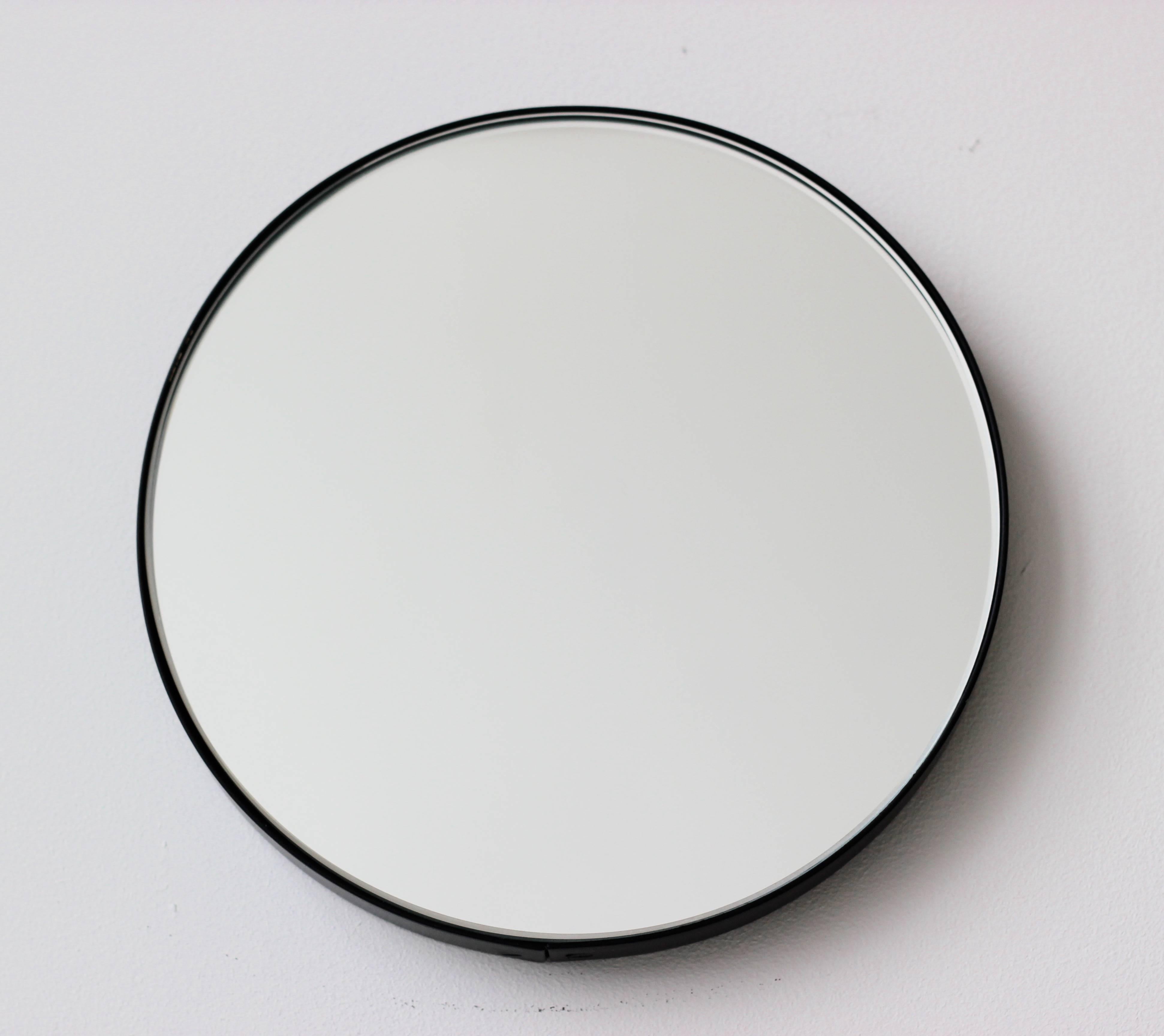 Minimalist round mirror with an elegant black powder coated aluminium frame. Designed and handcrafted in London, UK.

Medium, large and extra-large mirrors (60, 80 and 100cm) are fitted with an ingenious French cleat (split batten) system so they