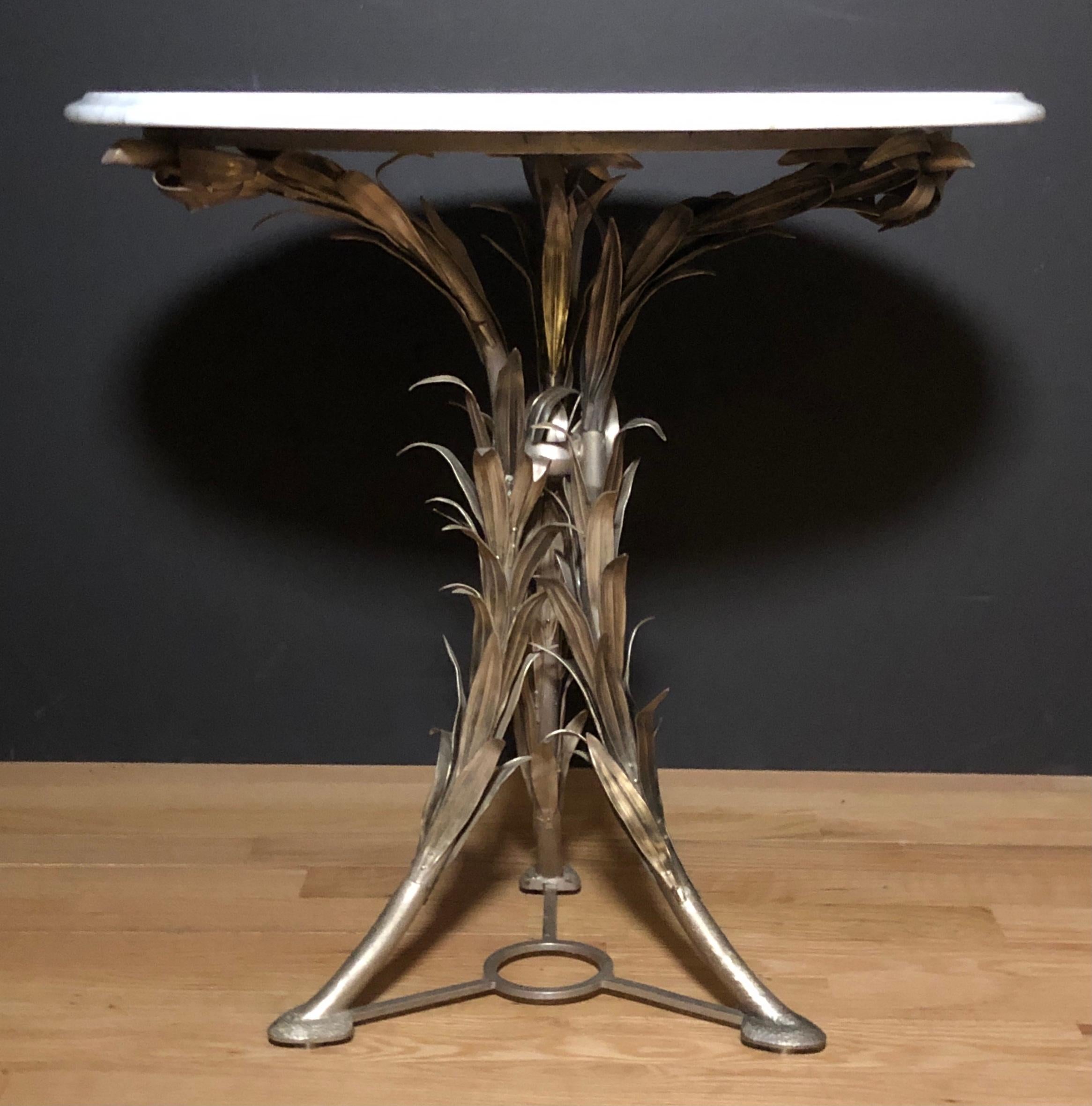 Exotic and unusual silver over bronze marble top center table, gueridon. Tripod form pedestal base with foliate reed style leaves covering legs. White marble top with light grey veining. 